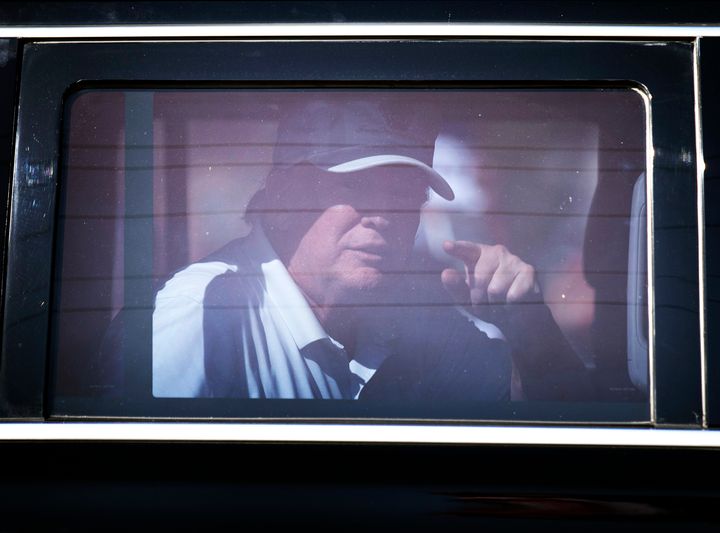 Former President Donald Trump reacts as he is driven past supporters on Presidents Day in West Palm Beach, Florida.