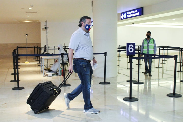 Ted Cruz wheels his luggage at the Cancun International Airport before boarding his plane back to the US.