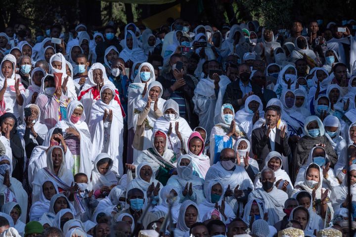 Pilgrims look on during a Mass service for Ethiopian Christmas at the Bale-wold Church, in Addis Ababa, Ethiopia, Thursday, Jan. 7, 2021. 