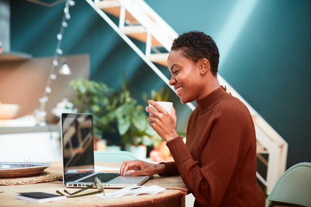 Woman working on her finances at home, filling up tax forms