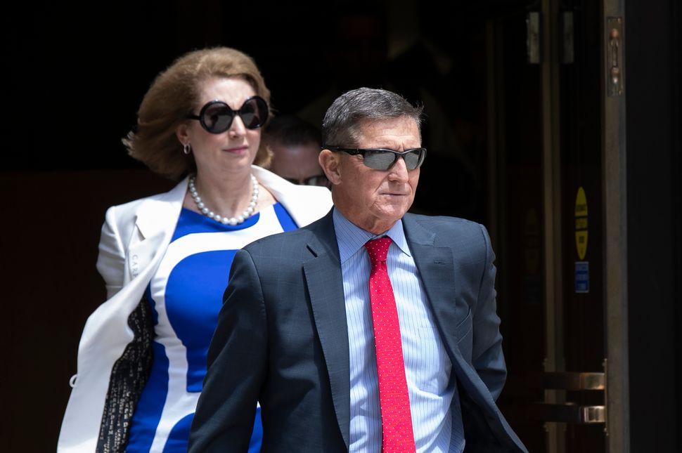 Flynn leaves the federal courthouse in Washington on June 24, 2019, followed by his lawyer Sidney Powell. She would become fa