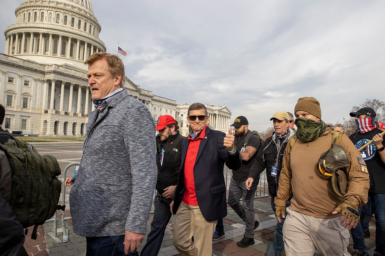 Flynn departs the Dec. 12, 2020, protest where he said Trump supporters trying to flip the election results were fighting “a spiritual battle for the heart and soul of this country.”