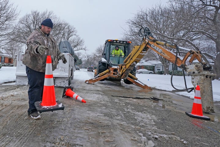 City employees prepare to work on a water main pipe that burst due to extreme cold in Richardson, Texas, on Wednesday.