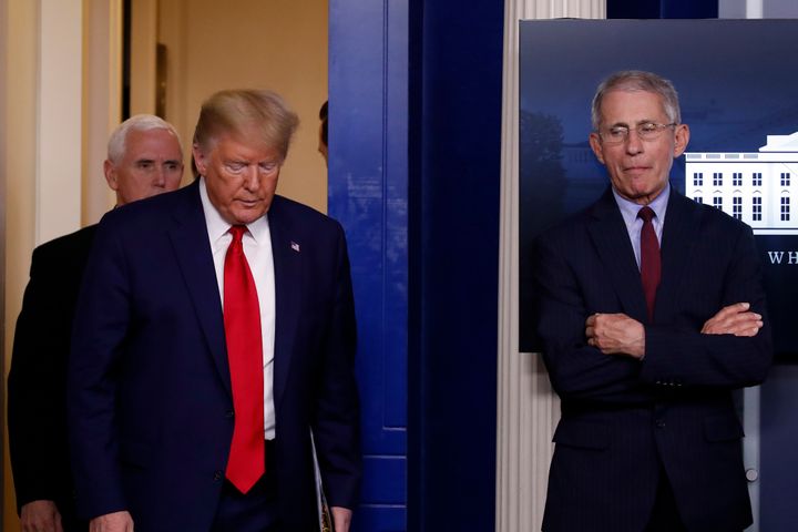 Then-President Donald Trump arrives with his vice president, Mike Pence, to speak to the press about the coronavirus on March 31, 2020, in Washington. At right is Dr. Anthony Fauci, director of the National Institute of Allergy and Infectious Diseases.