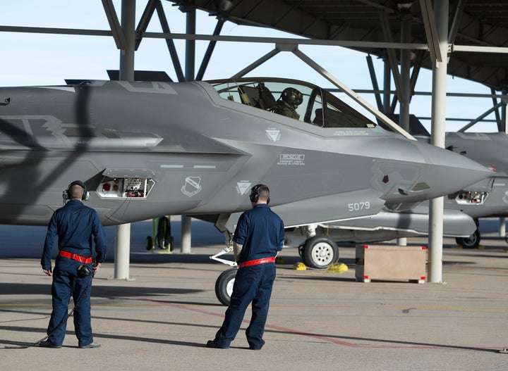 Ground crew members prepare an F-35 fighter jet for a training mission at Hill Air Force Base on March 15, 2017 in Ogden, Uta