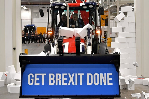 Boris Johnson drives a Union flag-themed JCB, with the words 