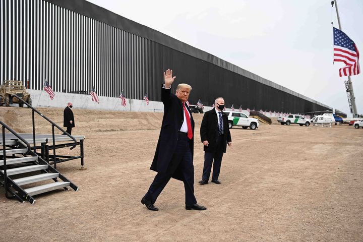 Donald Trump waves after speaking and touring a section of the border wall in Alamo, Texas, near the end of his presidency on
