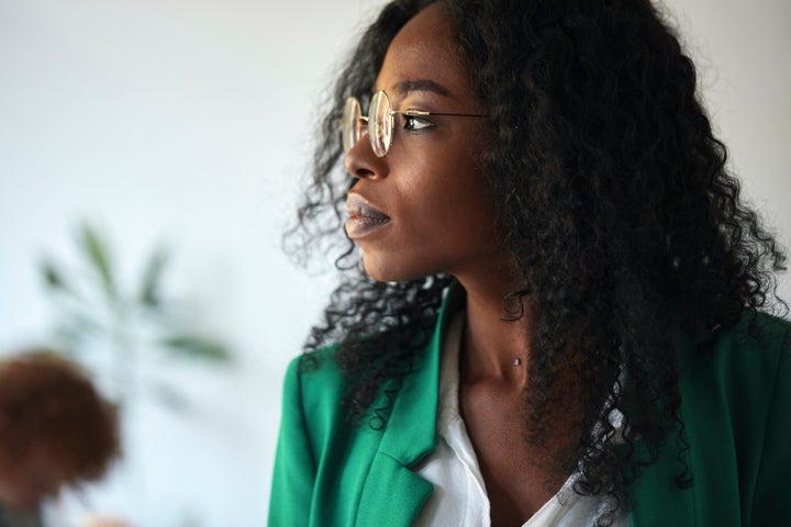 A businesswoman looks to the side in her office.