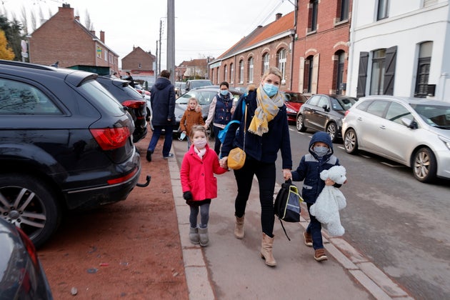 French anaesthesiologist Caroline Tesse, 34, walks with her children Margaux and Louis to school in Villeneuve d'Ascq 