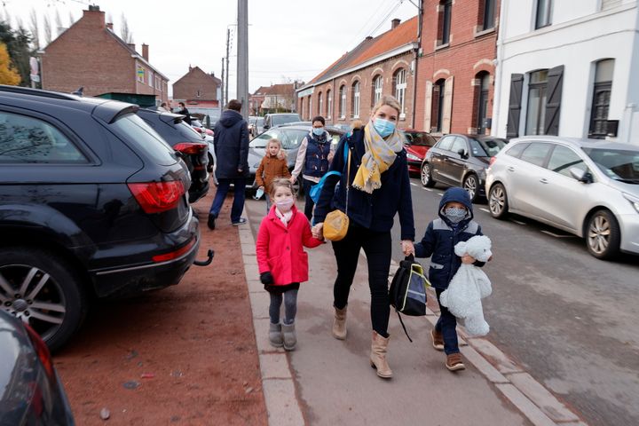 French anaesthesiologist Caroline Tesse, 34, walks with her children Margaux and Louis to school in Villeneuve d'Ascq 