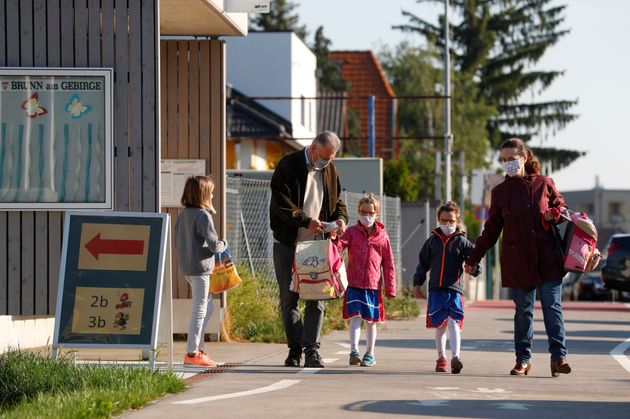 Children with their parents arrive at a primary school in Brunn am Gebirge, Austria, May 18