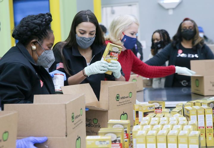 U.S. Rep. Sheila Jackson Lee (D-Texas), Rep. Alexandria Ocasio-Cortez (D-N.Y.) and Rep. Sylvia Garcia (D-Texas) load boxes at their work station at the Houston Food Bank in Houston, Texas, on Feb. 20, 2021.