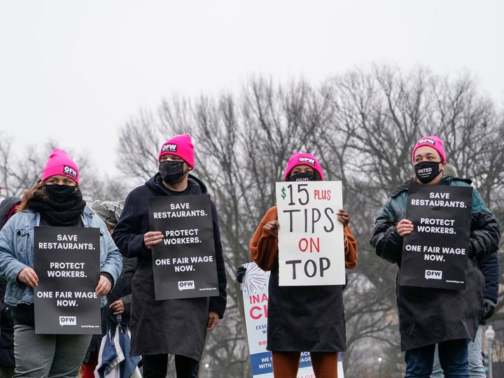 Service industry workers at a Jan. 26 rally in Washington express support for raising the national minimum wage to $15 an hour.