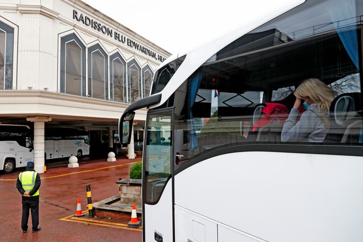 A woman arrives in a coach at the Radisson Blu hotel, where travellers are spending their mandatory hotel quarantine, at Heathrow Airport