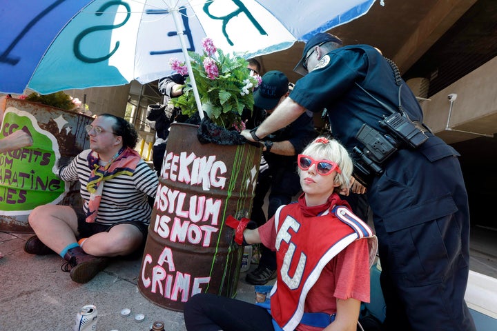 Protestors demonstrate outside the headquarters of CoreCivic Aug. 6, 2018, in Nashville.