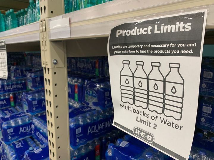 A "Product Limits" sign appears on water shelves in a Houston supermarket on Feb. 20, following a winter storm that left millions without power and caused water pipes to burst.