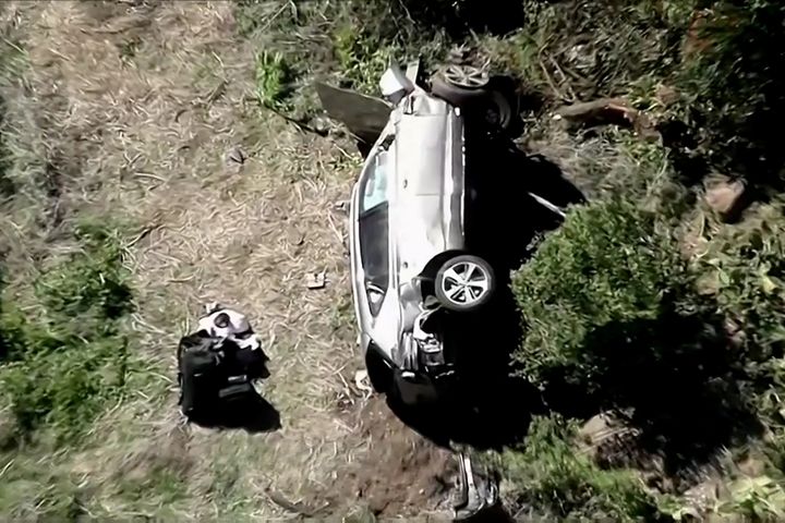 The vehicle of golfer Tiger Woods, who was rushed to hospital after suffering multiple injuries, lies on its side after being involved in a single-vehicle accident in Los Angeles.