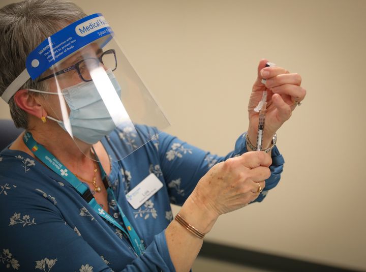 A nurse prepares a dose of the COVID-19 vaccine in Calgary on Dec. 15, 2020.