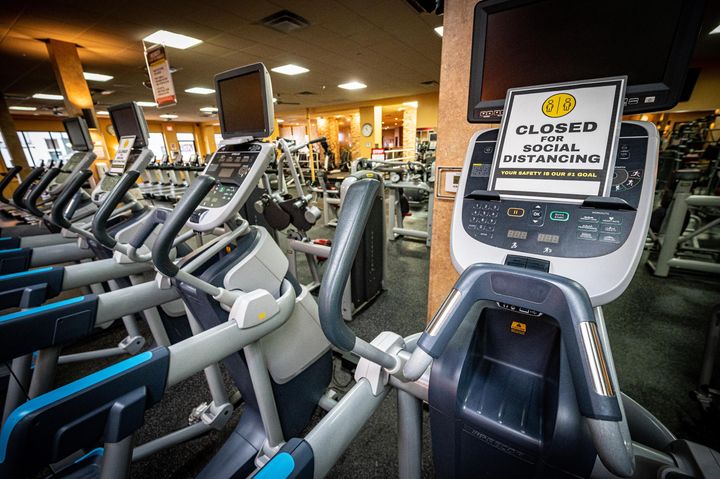 Social distancing signs on machines at Gold's Gym in East Northport, New York, on Aug. 19, 2020, ahead of reopening after the coronavirus shutdown.