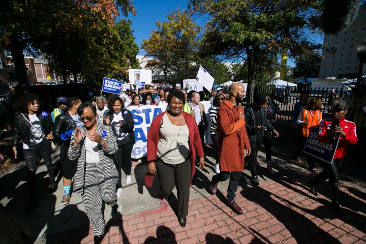 Then-Georgia gubernatorial candidate Stacey Abrams and Grammy-winning artist Common leads voters during a "Souls to the Polls" march in downtown Atlanta on Oct. 28, 2018, in Atlanta.