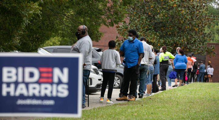 People stand in line on the first day of early voting for the general election at the C.T. Martin Natatorium and Recreation Center on Oct. 12, 2020, in Atlanta. Early voting in Georgia ran from Oct. 12-30.