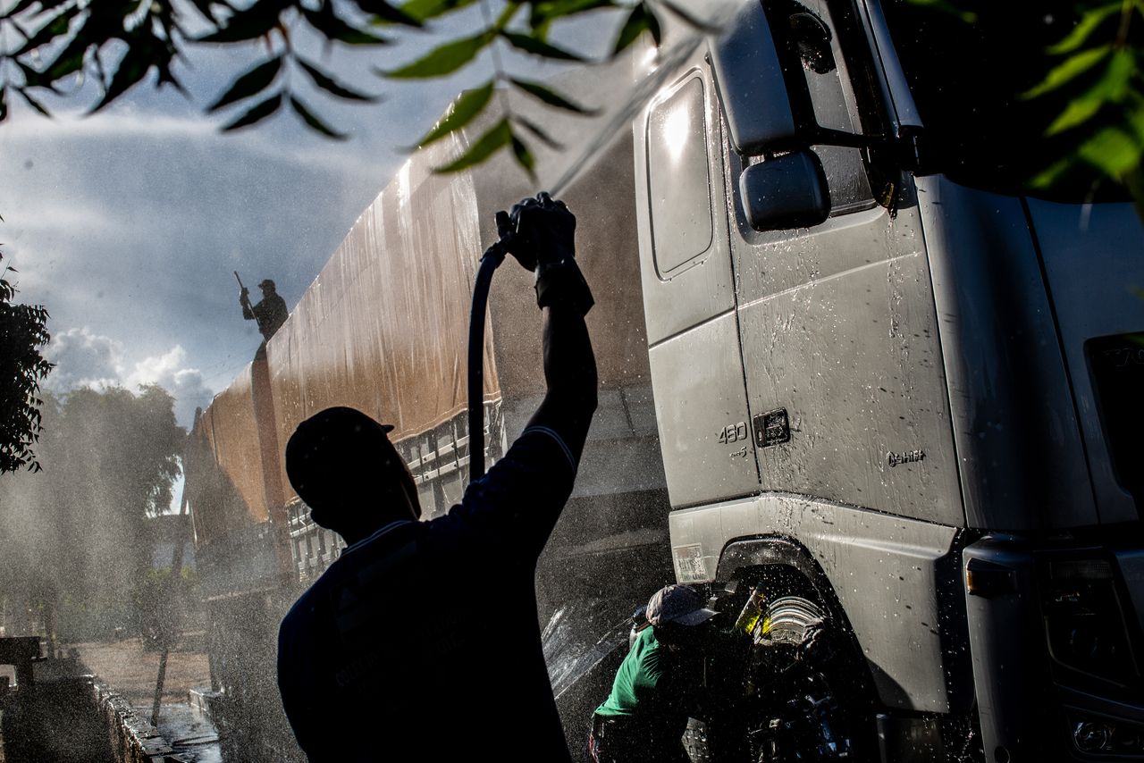 Workers clean a soy truck near Barreiros in Bahia.