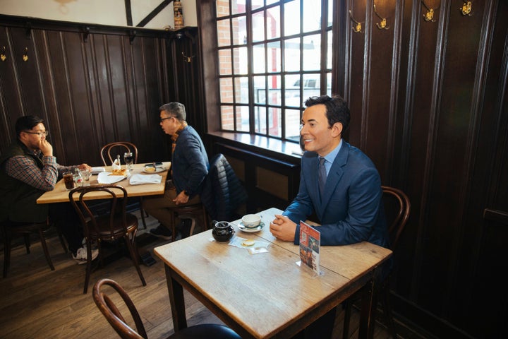 A wax statue of comedian Jimmy Fallon occupies a table at the steakhouse.