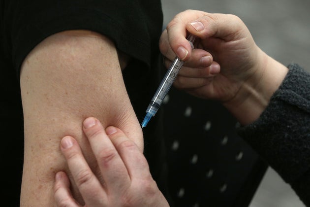 Pharmacy technicians in Toronto finish their COVID-19 vaccine training by injecting each other with a saline solution on Jan. 21.
