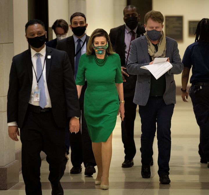 Speaker of the House Nancy Pelosi (D-Calif.) walks to a news conference Friday about the COVID-19 financial relief package and the proposal to increase the federal minimum wage to $15 an hour.