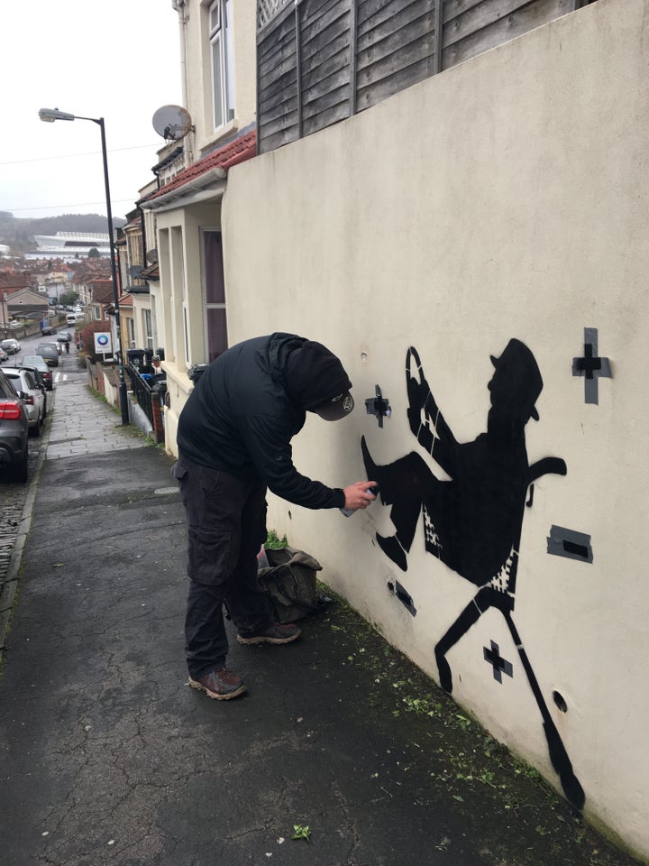 Street artist DIFF pictured painting his tribute to his father and the coronavirus vaccine in Bristol, England.