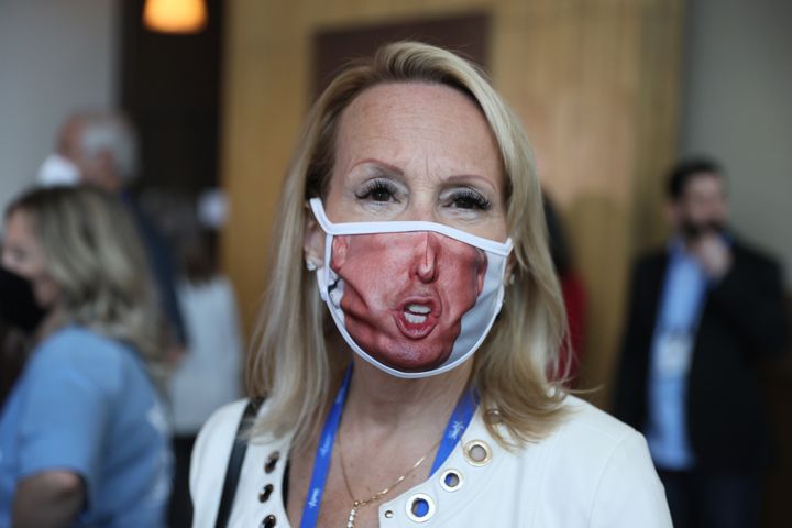 A visitor (who didn't want to provide her name) wears a face mask with a picture of former President Donald Trump on it durin