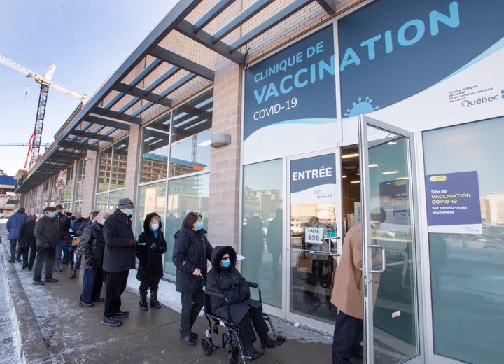 Seniors 85 and over line up for their shots at a COVID-19 vaccination clinic on Friday in Laval, Que.