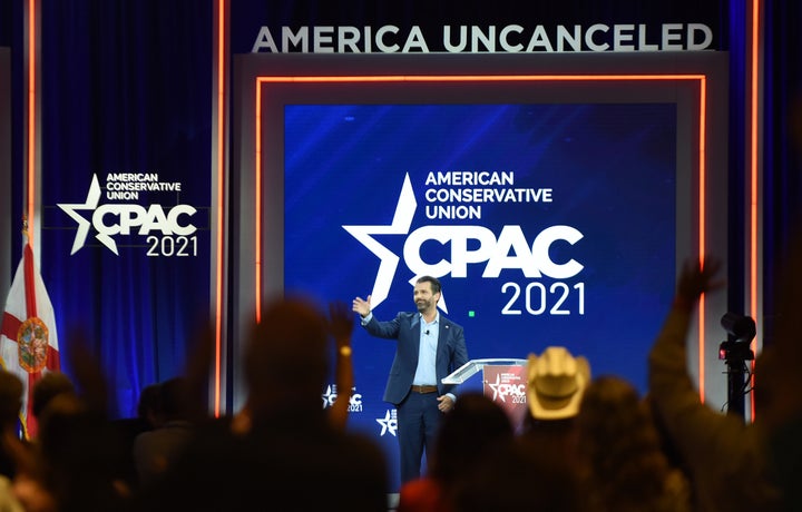 Donald Trump, Jr. waves as he leaves the stage after addressing attendees at the 2021 Conservative Political Action Conferenc