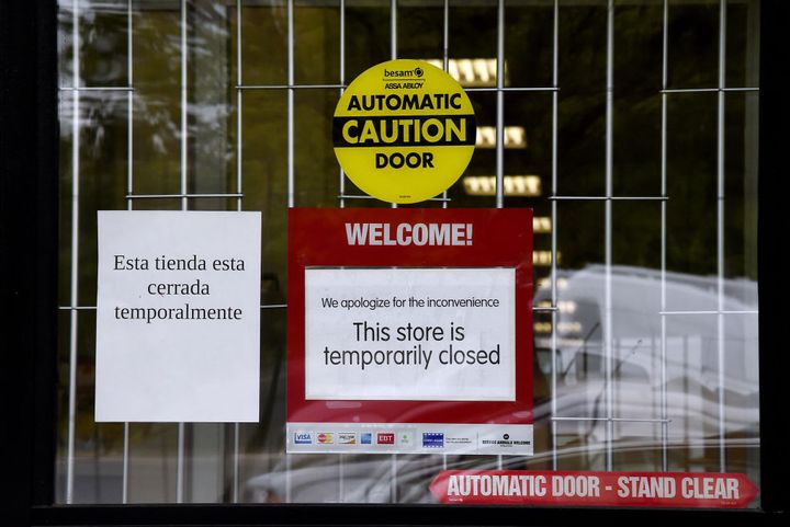 A sign "Temporarily Closed" is seen in front of a store amid the coronavirus pandemic on May 14, 2020, in Arlington, Virginia.