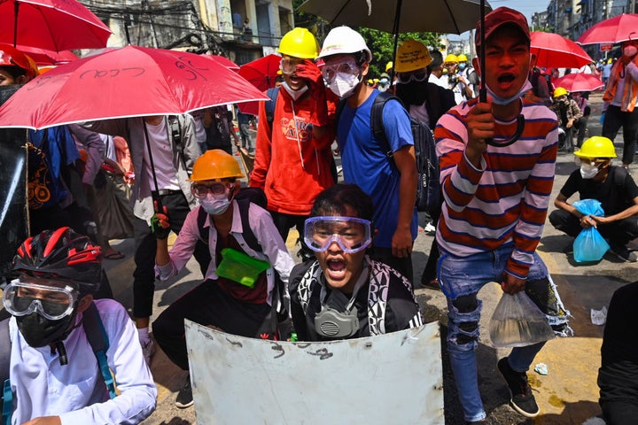 Protesters react during a demonstration against the military coup in Yangon on March 1, 2021. 