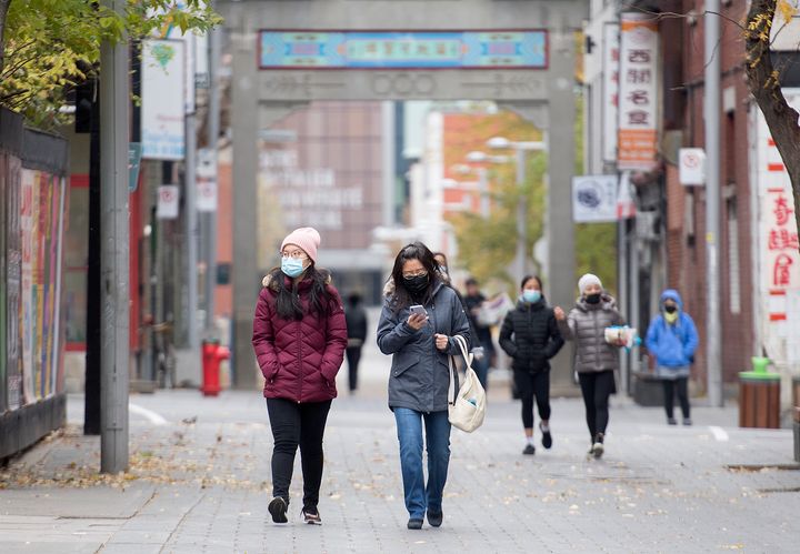 People make their way along a street in Montreal's Chinatown.