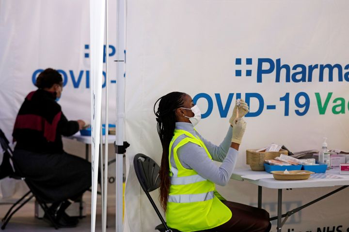A pharmacist draws up a dose of the AstraZeneca/Oxford Covid-19 vaccine at a temporary vaccine centre in Maidstone, southeast England