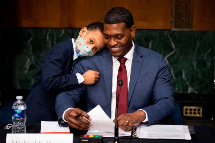 Michael Regan is hugged by his son, Matthew, at the conclusion of his confirmation hearing Feb. 3 before the Senate Environme