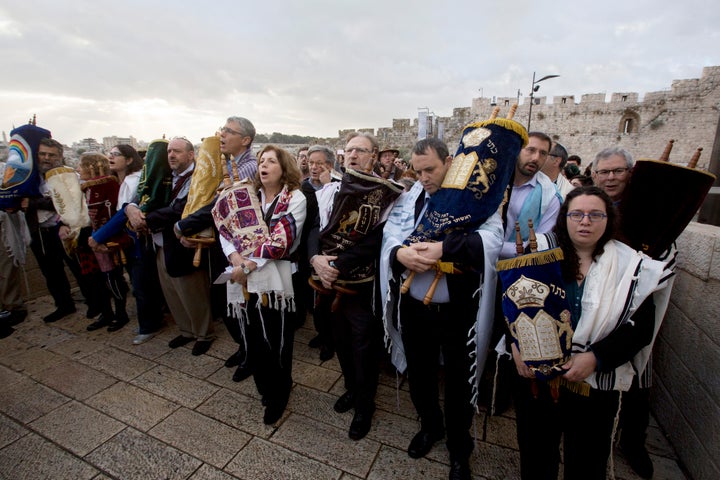 The heads of the Jewish Reform and Conservative movements carry Torah scrolls as they march to the Western Wall in Jerusalem'