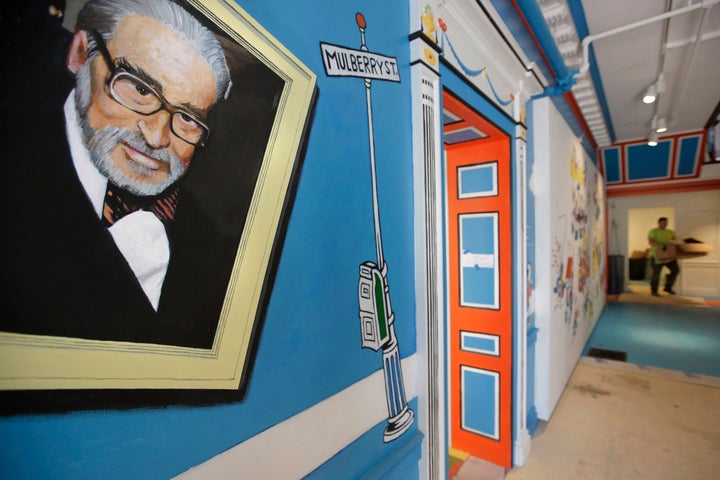 A mural that features Theodor Seuss Geisel, left, also known by his pen name Dr. Seuss, covers part of a wall near an entrance at The Amazing World of Dr. Seuss Museum, in Springfield, Mass., seen on May 4, 2017.