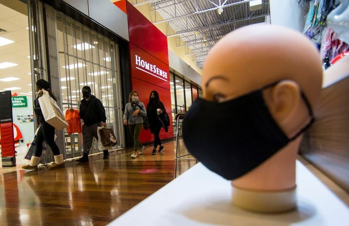 People wearing face masks are seen at Vaughan Mills shopping mall in Vaughan, Ont., Nov. 18, 2020. Canada's economy got off to a strong start in January, despite a record decline in 2020.