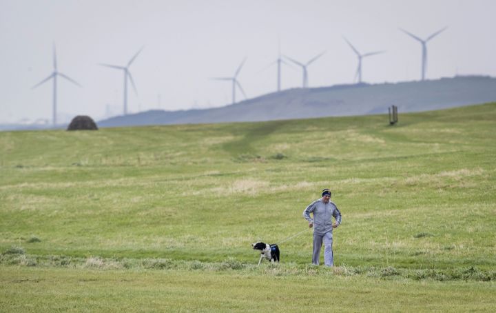A man walking his dog near Whitehaven in Cumbria, where the proposed mine will be built