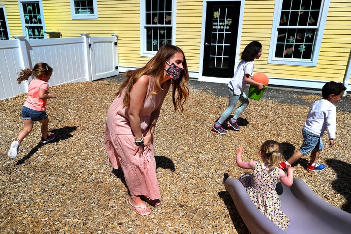 Preschool teacher Jenna Grenier keeps an eye on the children at Magical Beginnings Learning Academy in Middleton, Massachusetts, on May 22, 2020.