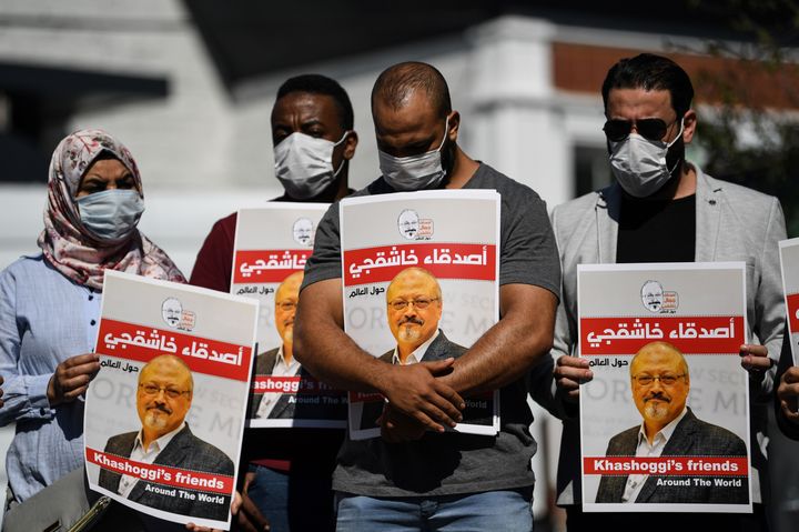 People hold posters bearing Khashoggi's picture at an Oct. 2, 2020, event marking the second-year anniversary of his death.