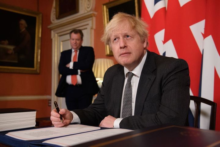 Boris Johnson poses for photographs after signing the trade and cooperation agreement between the UK and the EU