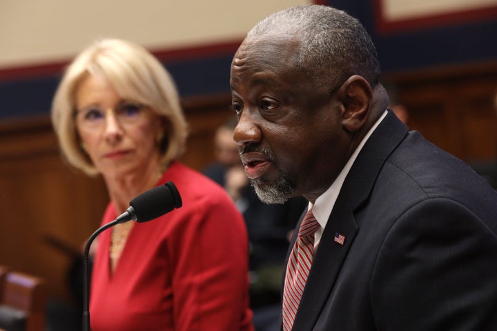 Betsy DeVos, who at the time was secretary of education, listens as Mark Brown, the head of the Federal Student Aid office, speaks during a hearing before the House Education and Labor Committee on Dec. 12, 2019.