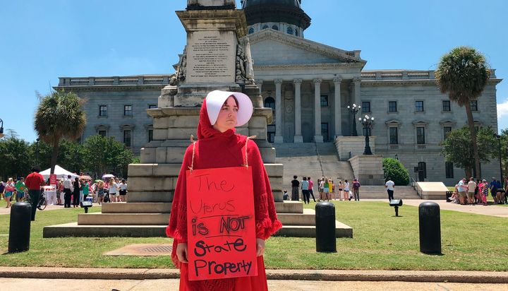 A woman dressed in a costume from "The Handmaid's Tale" silently protests during a rally to maintain abortion rights on May 21, 2019, in front of the Statehouse in Columbia, S.C. Similar rallies were taking place across the country.