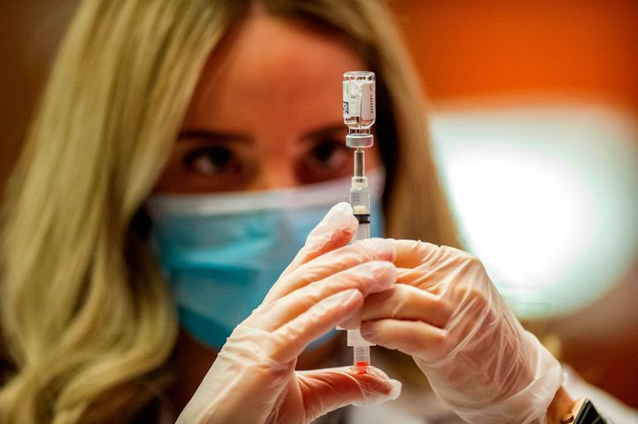 Pharmacist Madeline Acquilano fills a syringe with the Johnson & Johnson COVID-19 Vaccine before inoculating members of the public at Hartford Hospital in Hartford, Connecticut, on March 3, 2021.