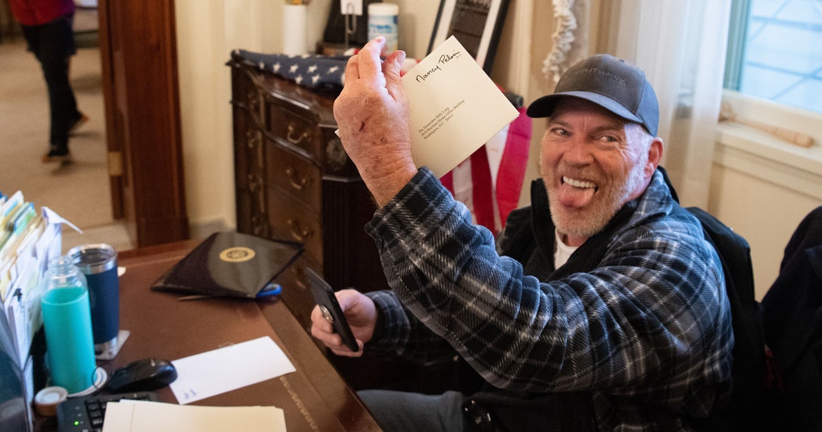 Insurrectionist Photographed In Nancy Pelosi's Office Says It's Unfair He Remains Jailed
