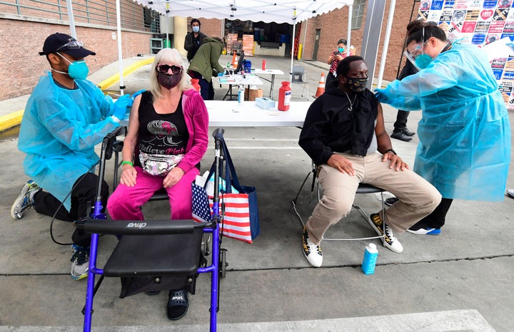 Registered nurses administer the Moderna COVID-19 vaccine to seniors experiencing homelessness at the Los Angeles Mission on Feb. 10, 2021.